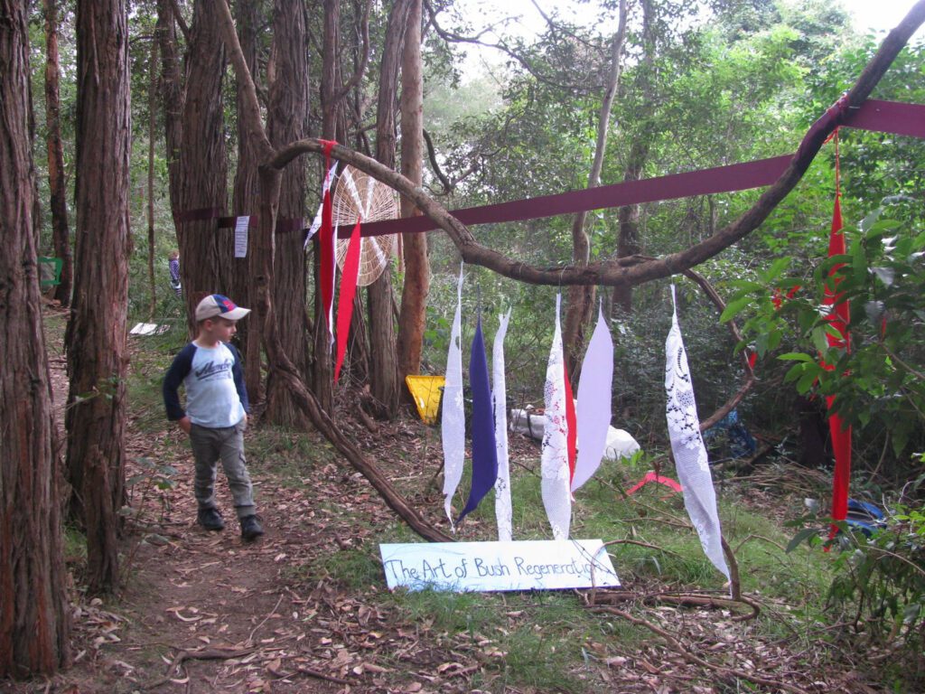 boy walks through decorated bush